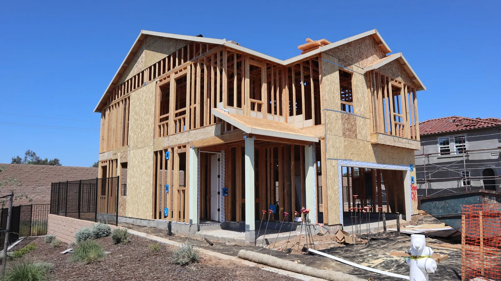 Two-story house under construction with wood framing