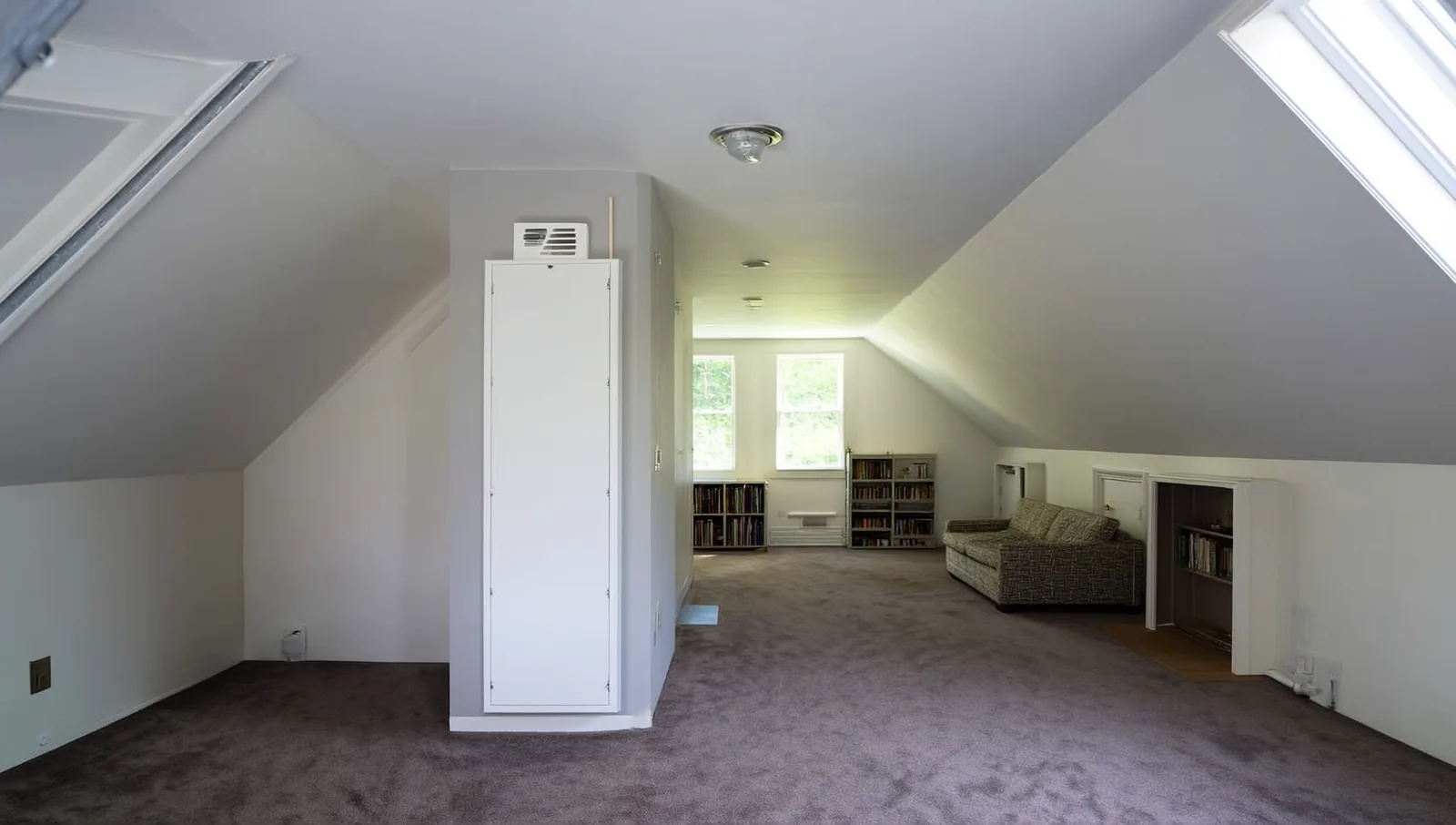 Finished bonus room with sloped ceilings and a dormer window