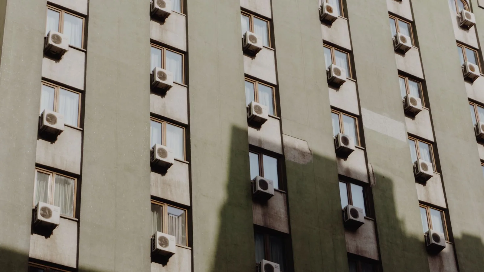 Apartment facade with an AC unit at each window